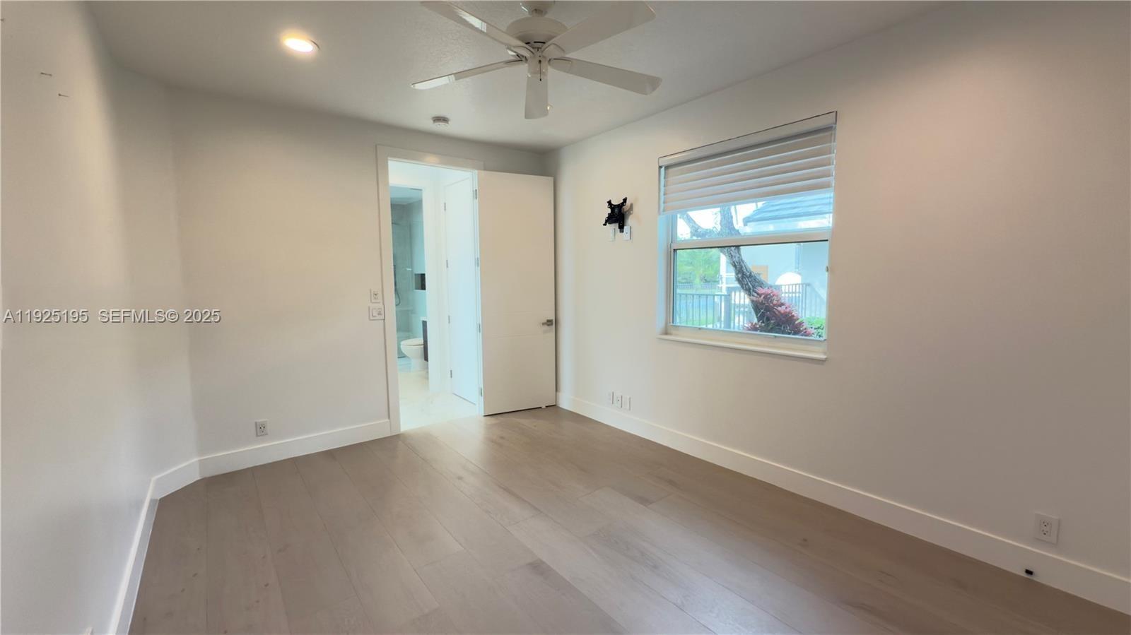 3763 Oak Ridge Circle Weston, FL 33331 - Photo 9 of 33 an empty room with wooden floor fan and windows