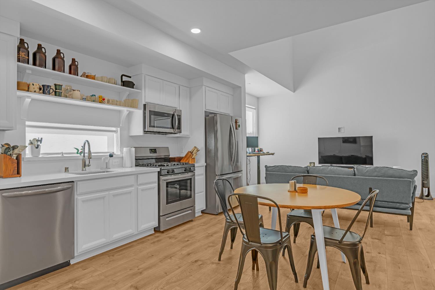 2431 Cleat Lane, Unit 301 Sacramento, CA 95818 - Photo 11 of 18 a kitchen with stainless steel appliances granite countertop a dining table and chairs
