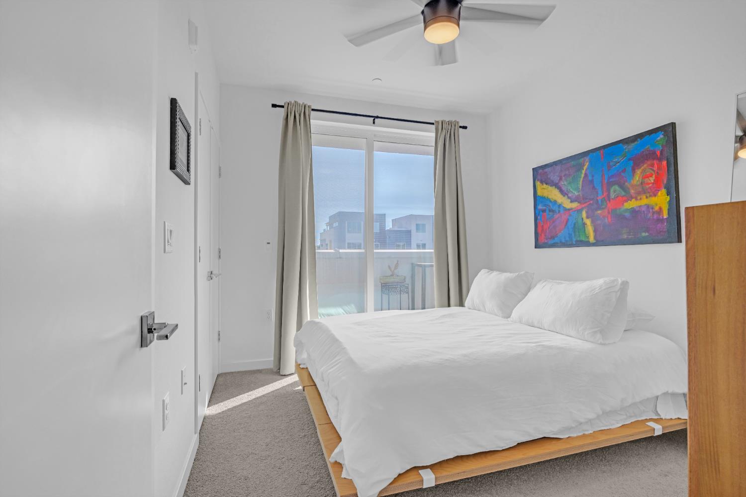 2431 Cleat Lane, Unit 301 Sacramento, CA 95818 - Photo 15 of 18 a bedroom with a bed and a painting on the wall