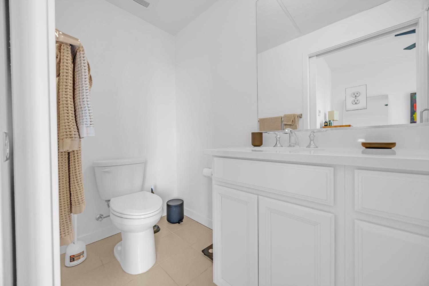 2431 Cleat Lane, Unit 301 Sacramento, CA 95818 - Photo 17 of 18 a bathroom with a sink toilet and mirror
