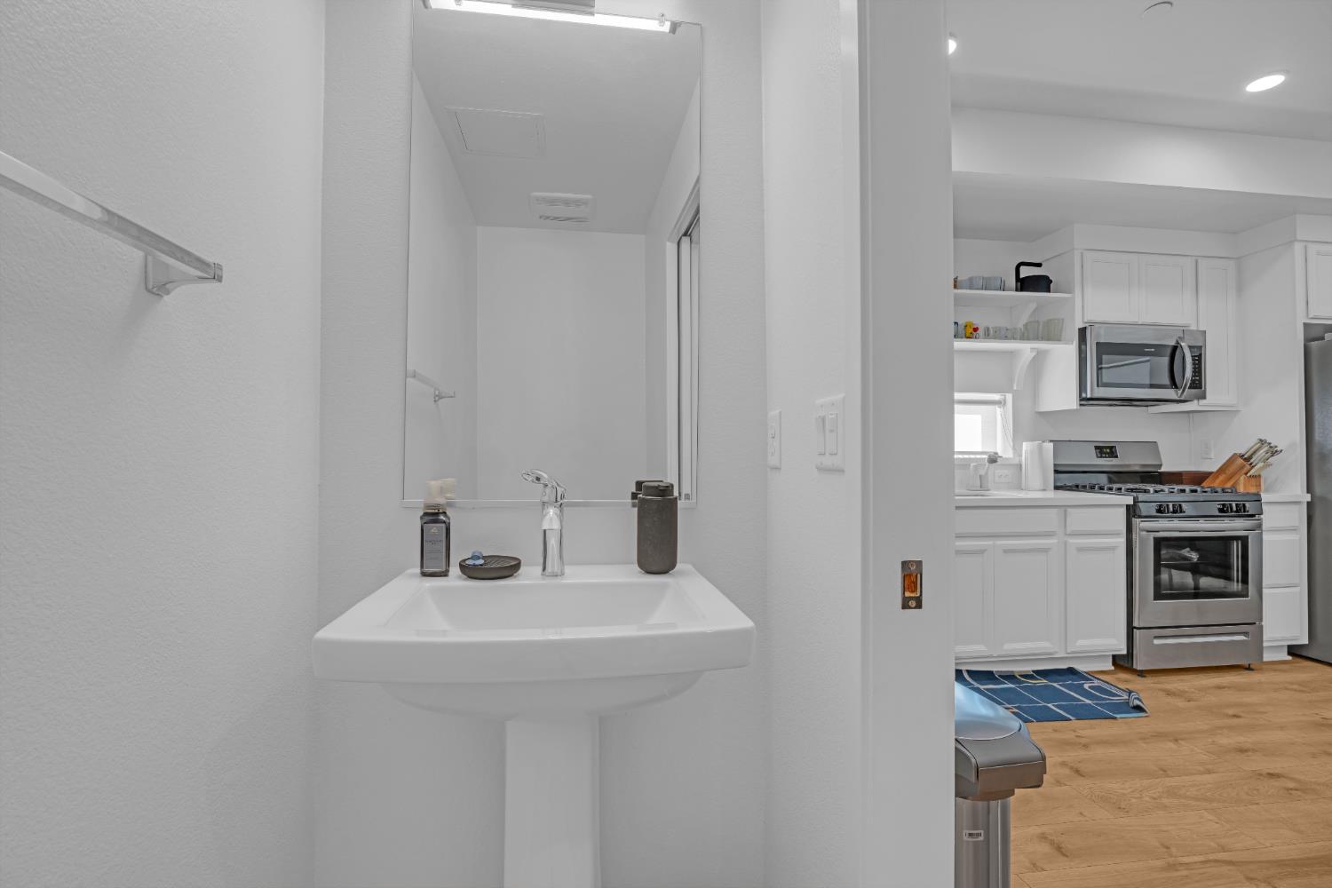 2431 Cleat Lane, Unit 301 Sacramento, CA 95818 - Photo 5 of 18 a bathroom with a sink and a mirror