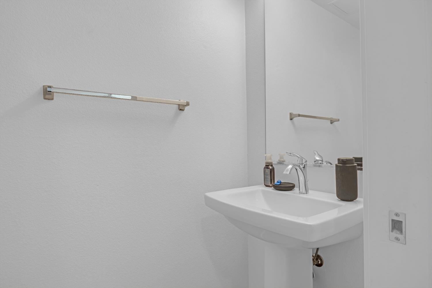 2431 Cleat Lane, Unit 301 Sacramento, CA 95818 - Photo 6 of 18 a bathroom with a sink and a mirror