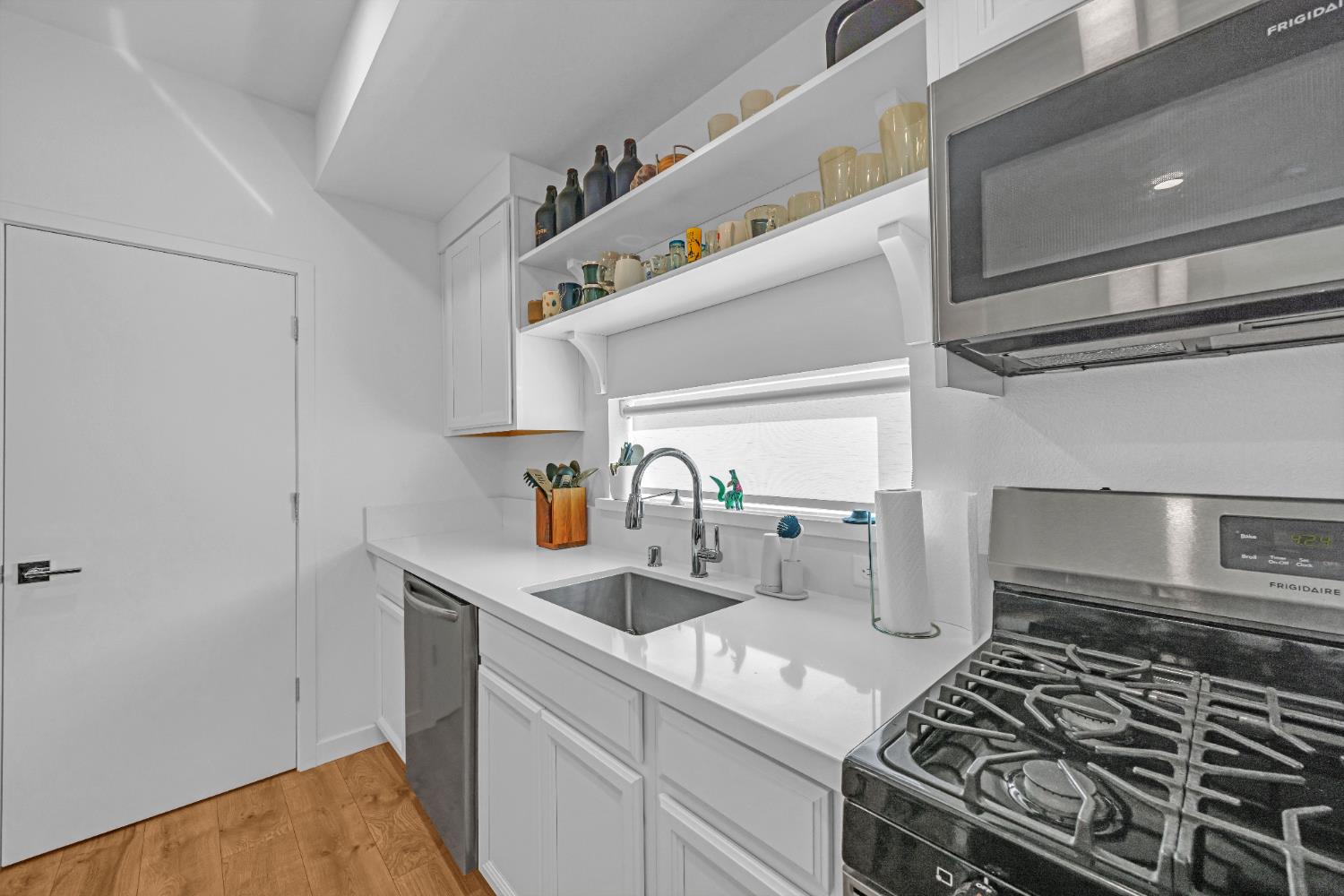 2431 Cleat Lane, Unit 301 Sacramento, CA 95818 - Photo 10 of 18 a kitchen with a stove and a sink