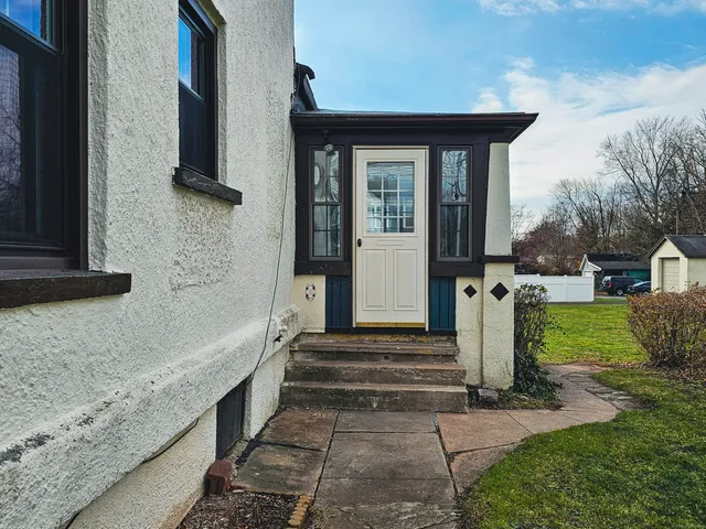 a front view of a house with a garden