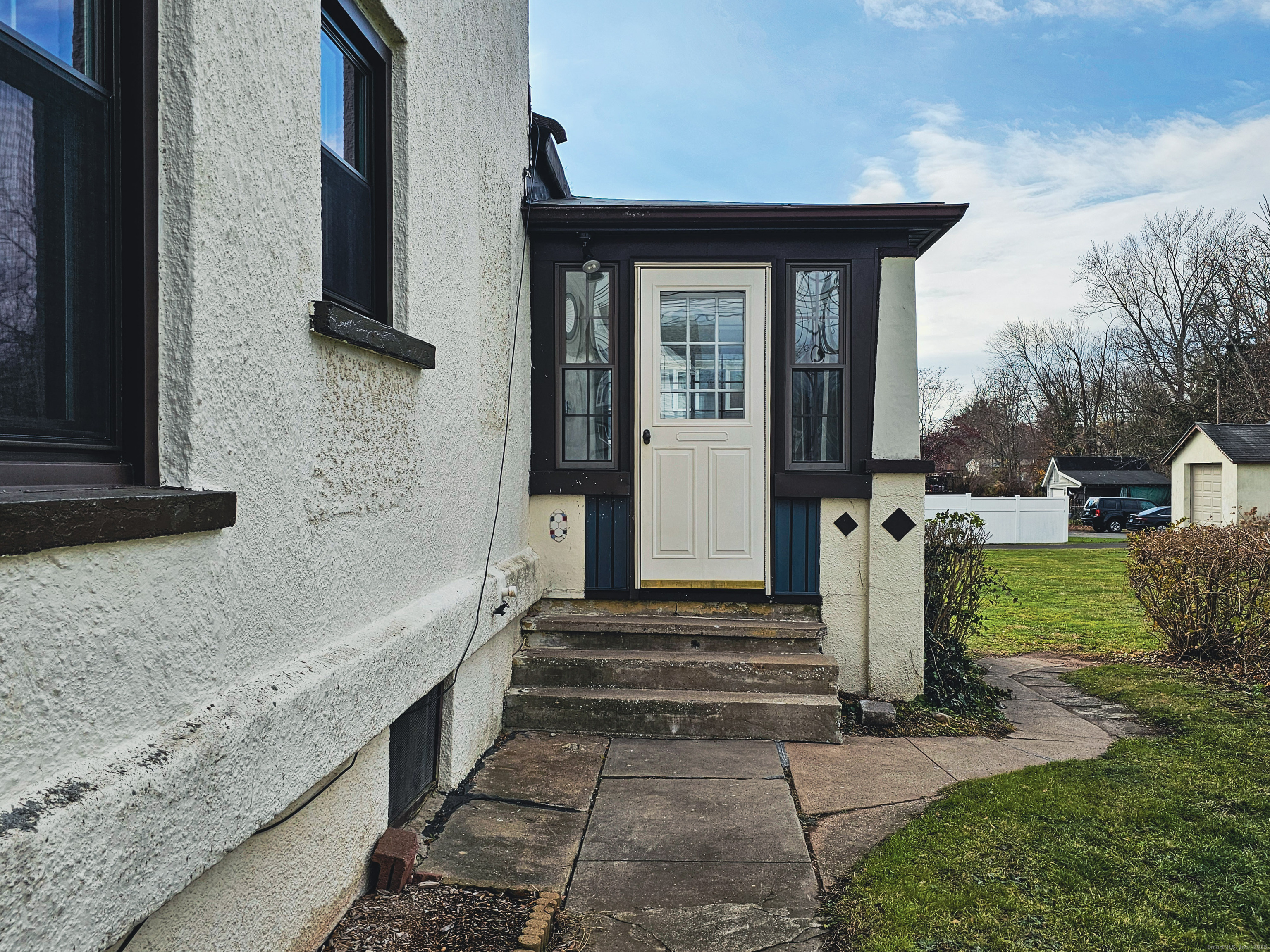 581 Center Street, Unit 1 Wallingford, CT 06492 - Photo 2 of 14 a front view of a house with a garden
