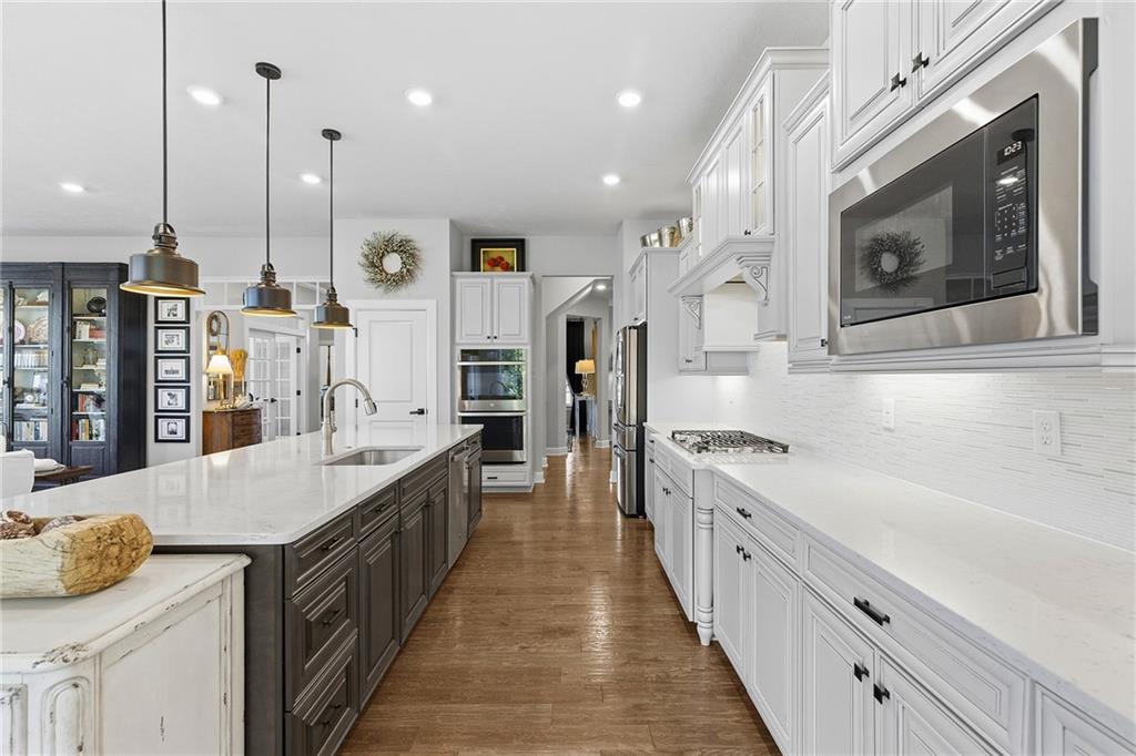 2015 Cherry Road Gibsonia, PA 15044 - Photo 11 of 50 a large kitchen with stainless steel appliances kitchen island granite countertop a large stove a sink dishwasher and white cabinets with wooden floor