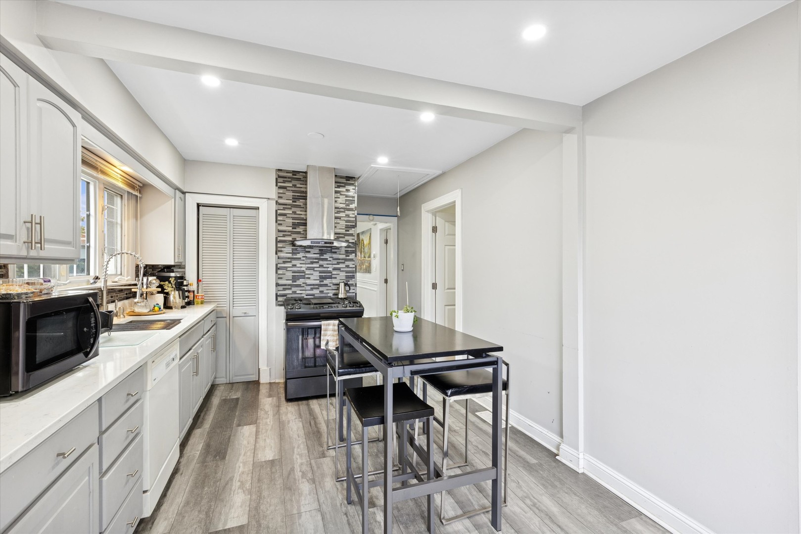 7211 West 58th Place Summit Argo, IL 60501 - Photo 4 of 15 a kitchen with stainless steel appliances kitchen island granite countertop a stove a sink and a refrigerator