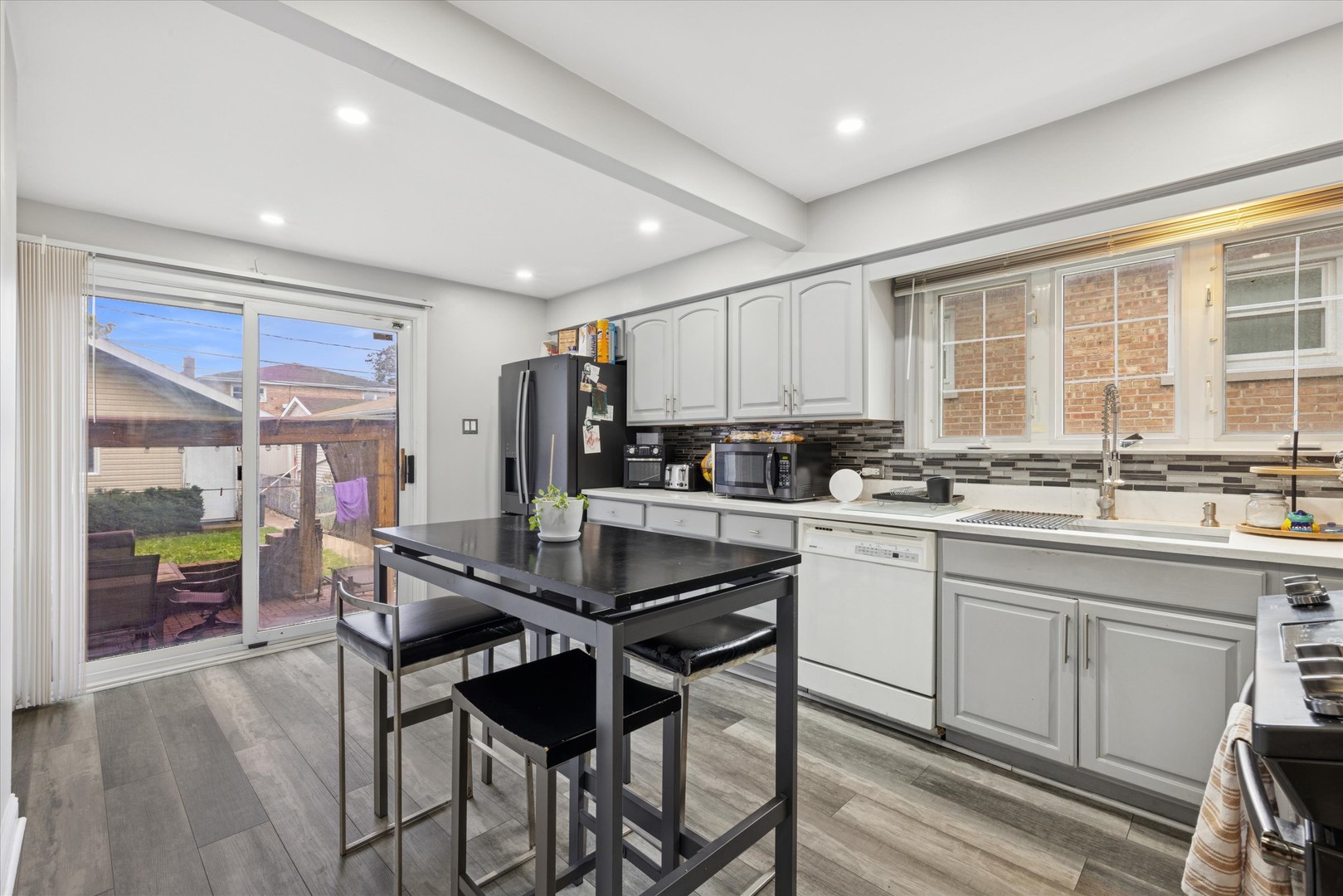 7211 West 58th Place Summit Argo, IL 60501 - Photo 5 of 15 a kitchen with a dining table chairs and refrigerator