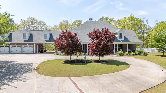 a front view of a house with a yard garage and outdoor seating