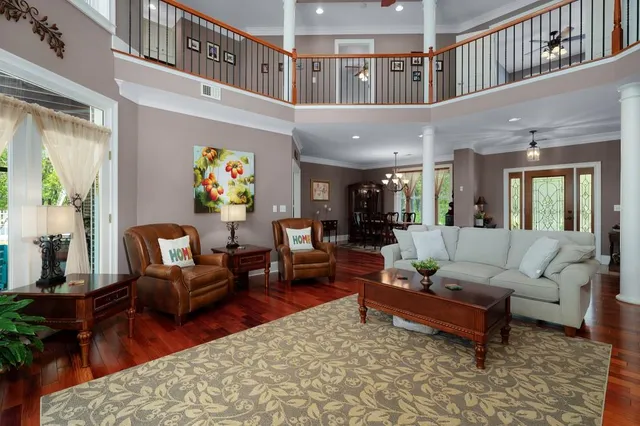 a kitchen with stainless steel appliances granite countertop a refrigerator a sink dishwasher and a dining table with garden view