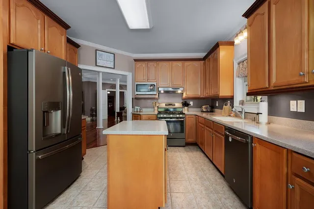 a view of a hallway with wooden floor and stairs