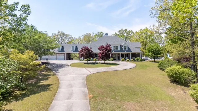 an aerial view of a house with swimming pool and porch with furniture