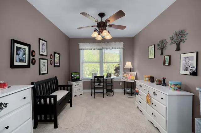 a view of a house with a yard and potted plants