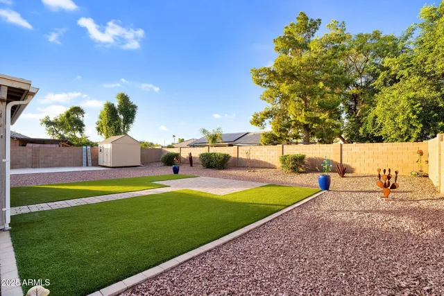 a view of a swimming pool with a yard and sitting area