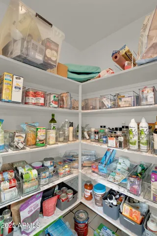 a kitchen with stainless steel appliances granite countertop a refrigerator a stove a dining table and chairs with wooden floor