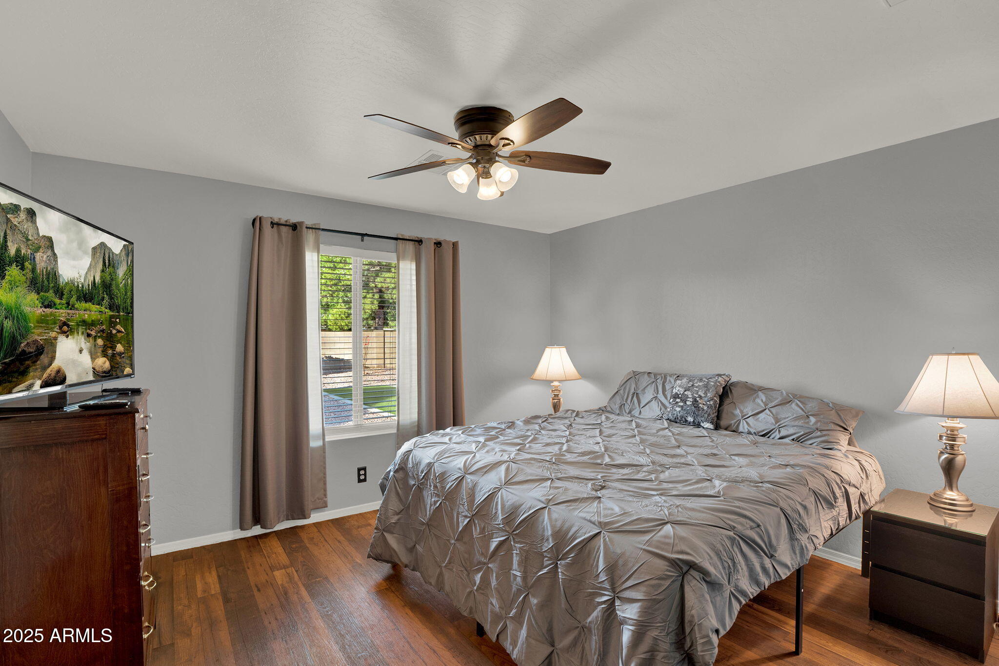 3058 East Erie Street Gilbert, AZ 85295 - Photo 18 of 36 a bedroom with a bed and a flat screen tv