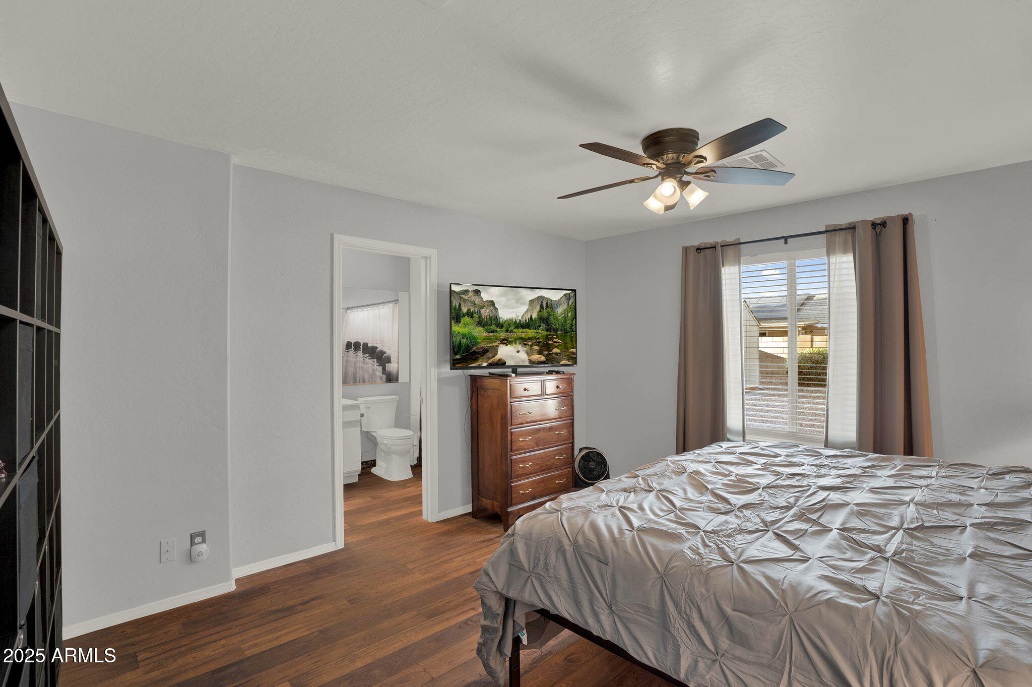 3058 East Erie Street Gilbert, AZ 85295 - Photo 20 of 36 a bedroom with a bed and a chandelier