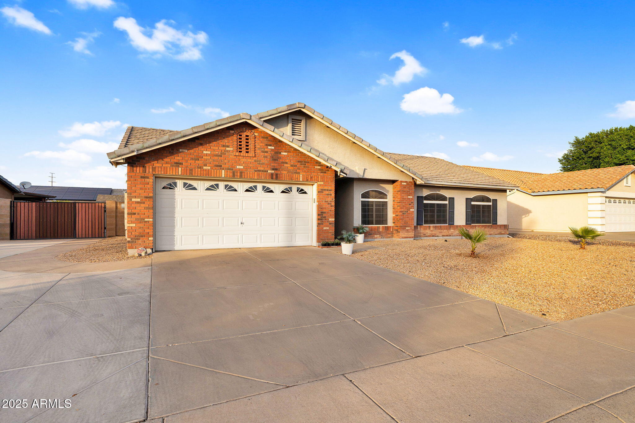 3058 East Erie Street Gilbert, AZ 85295 - Photo 2 of 36 a front view of a house with a yard and garage