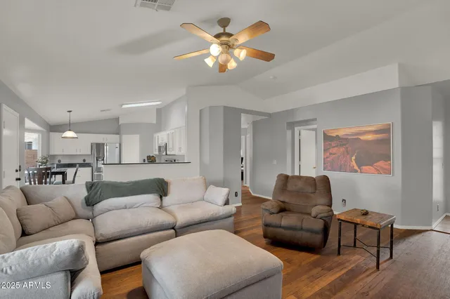 a living room with furniture and kitchen view