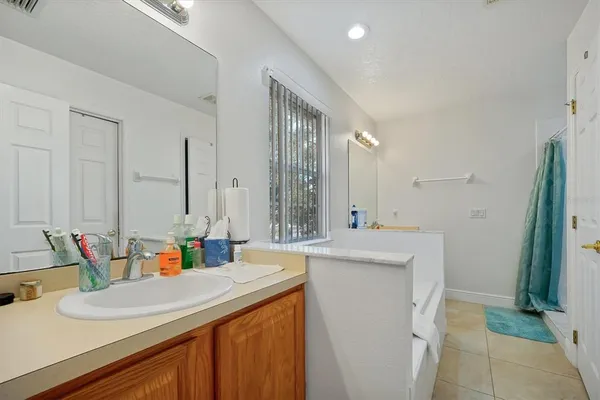 a bathroom with a sink double vanity and a tub
