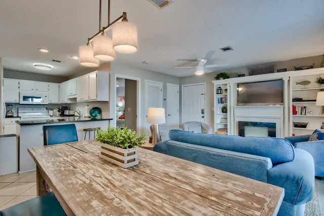 a living room with furniture and a kitchen view