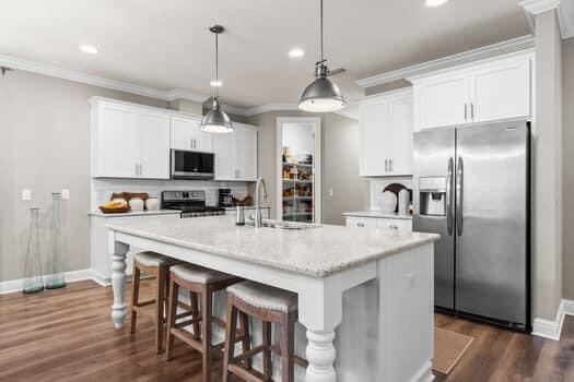 48 Barefoot Cove Freeport, FL 32439 - Photo 20 of 82 a kitchen with kitchen island a counter space a sink appliances and cabinets