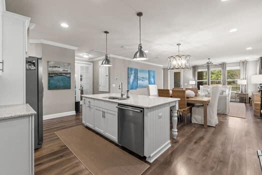 48 Barefoot Cove Freeport, FL 32439 - Photo 23 of 82 a large kitchen with kitchen island a sink and a wooden floor