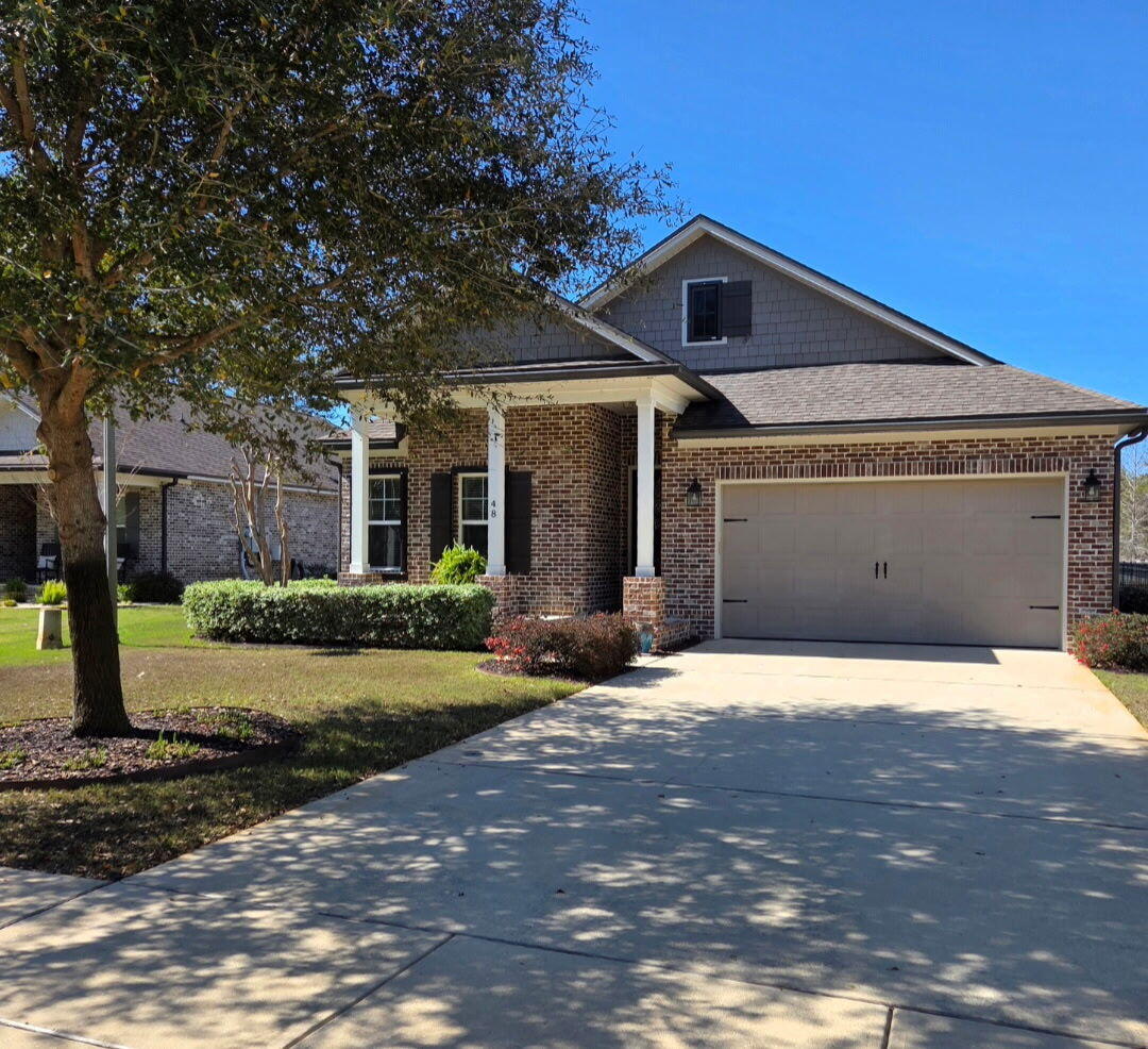 48 Barefoot Cove Freeport, FL 32439 - Photo 4 of 82 a front view of a house with a yard and garage