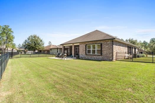 48 Barefoot Cove Freeport, FL 32439 - Photo 53 of 82 a front view of house with yard and trees in the background
