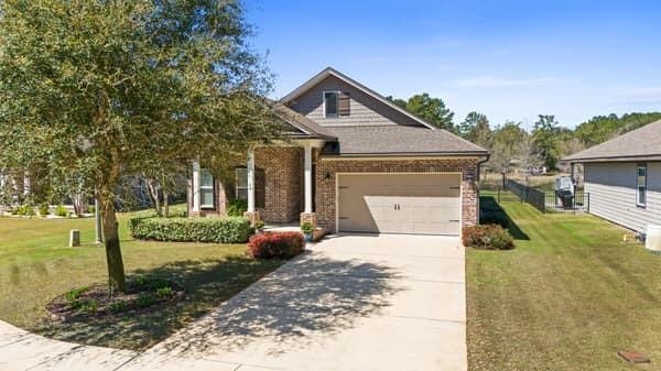 48 Barefoot Cove Freeport, FL 32439 - Photo 61 of 82 a front view of a house with a yard and garage