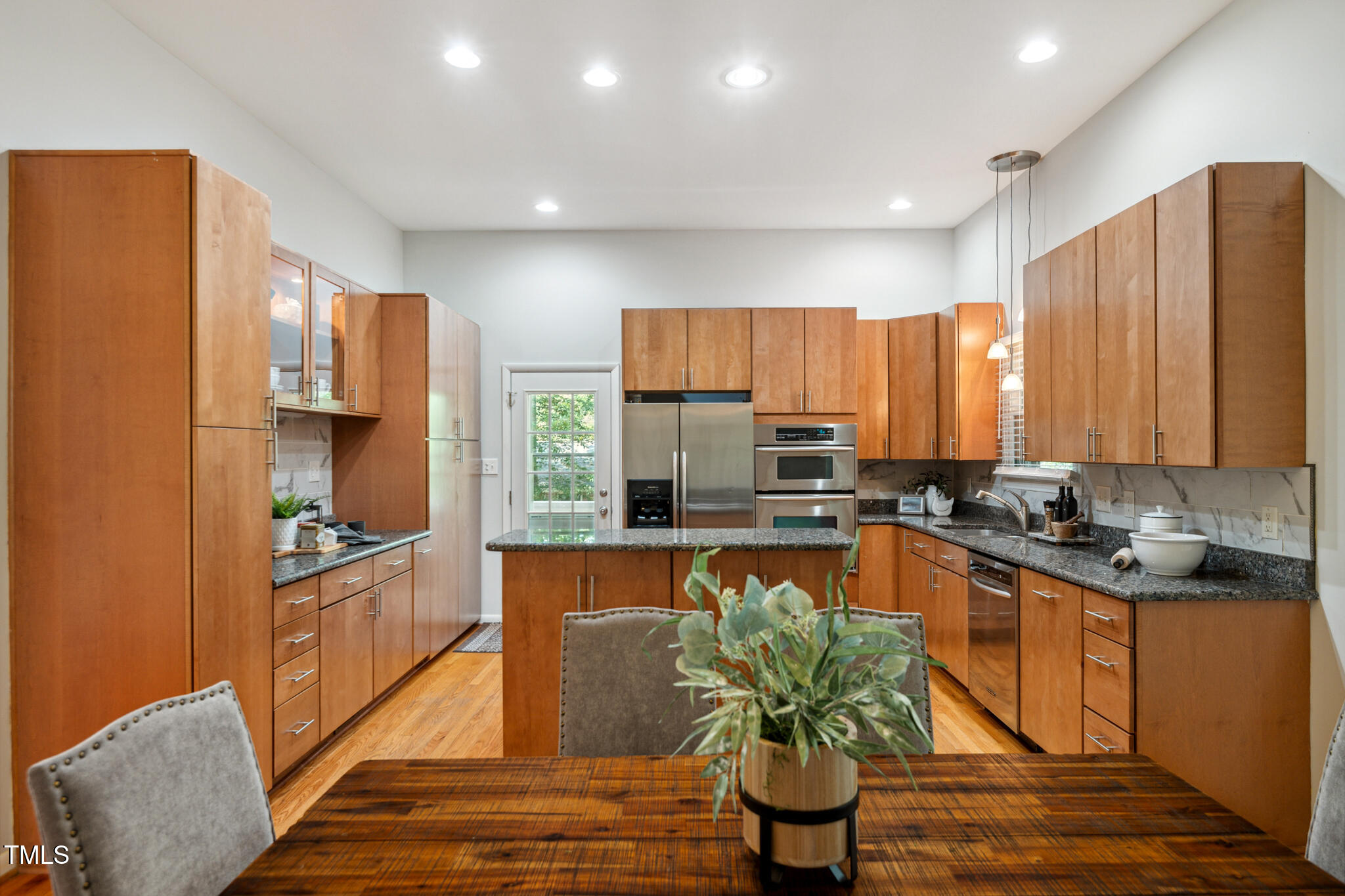 205 Northfield Drive Raleigh, NC 27609 - Photo 22 of 87 a kitchen with stainless steel appliances granite countertop a refrigerator a stove and a sink