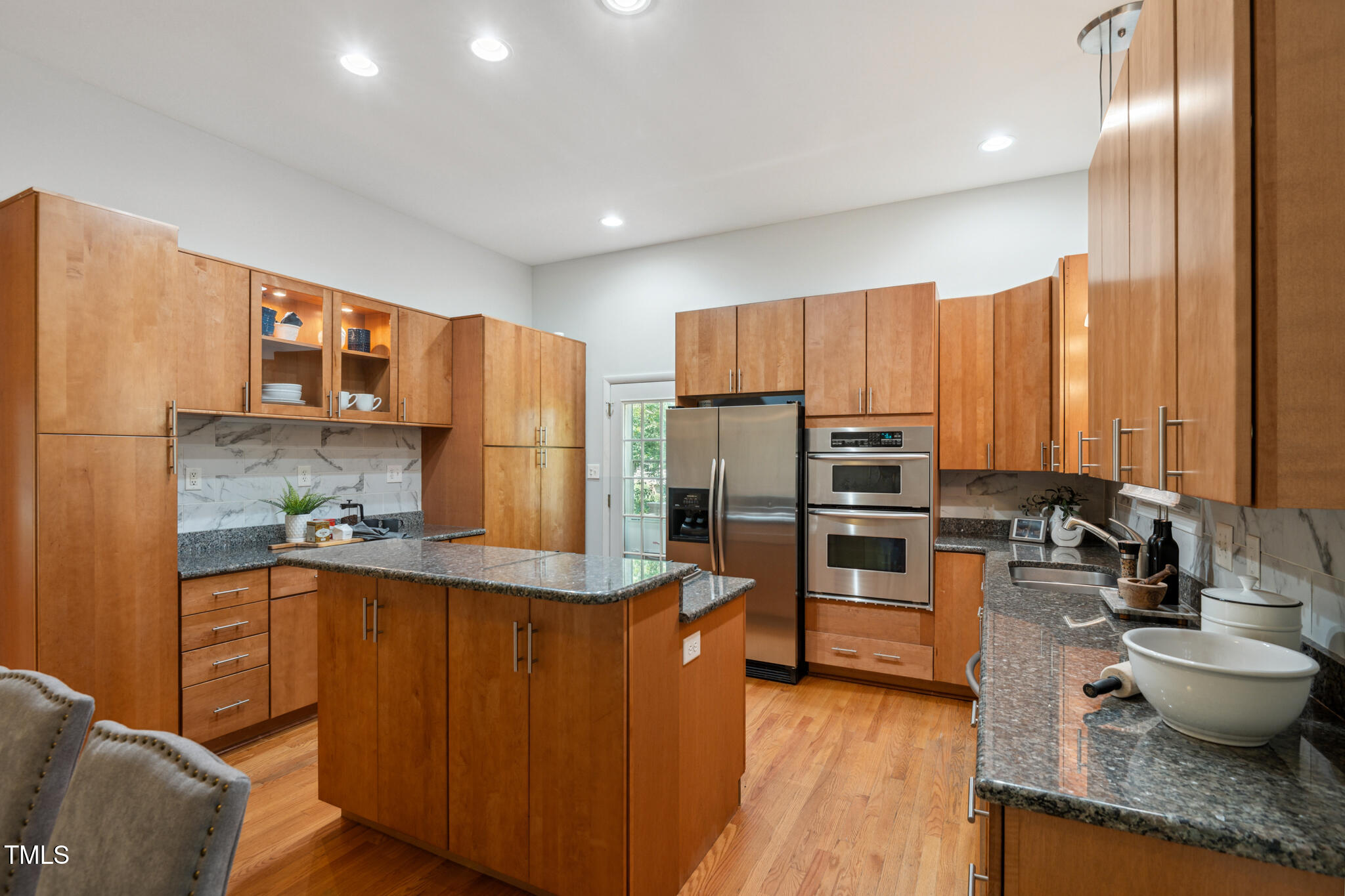 205 Northfield Drive Raleigh, NC 27609 - Photo 23 of 87 a kitchen with stainless steel appliances a refrigerator and wooden floor