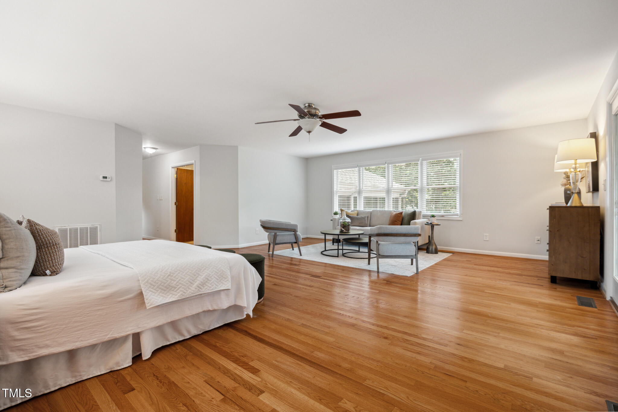205 Northfield Drive Raleigh, NC 27609 - Photo 40 of 87 a bedroom with a bed and a chair with the wooden floor