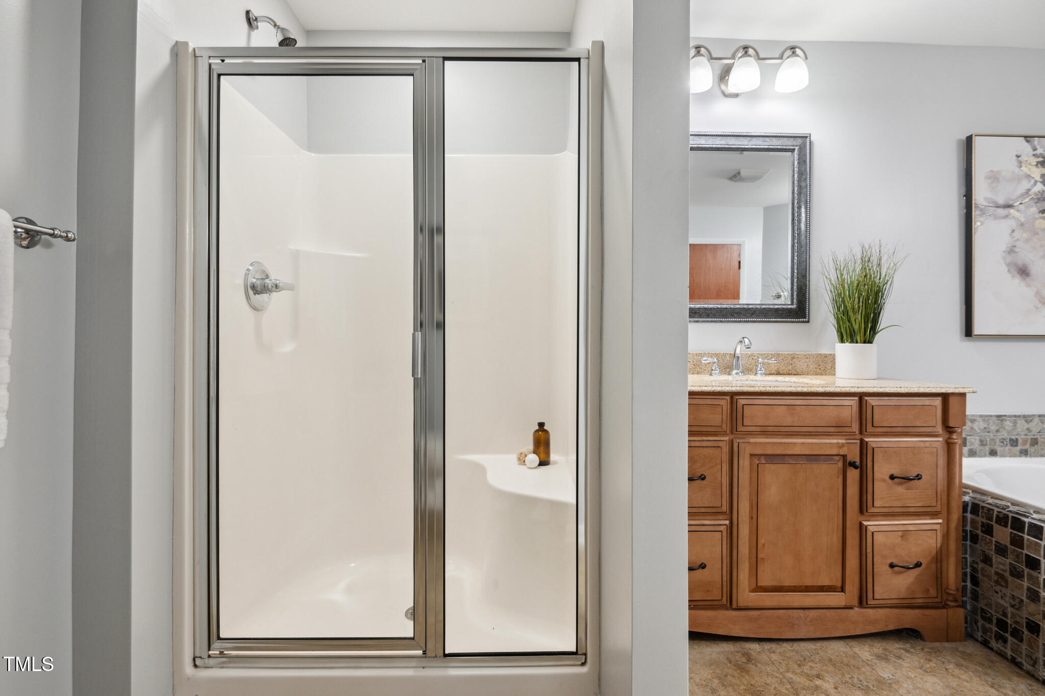 205 Northfield Drive Raleigh, NC 27609 - Photo 46 of 87 a bathroom with a shower sink and mirror