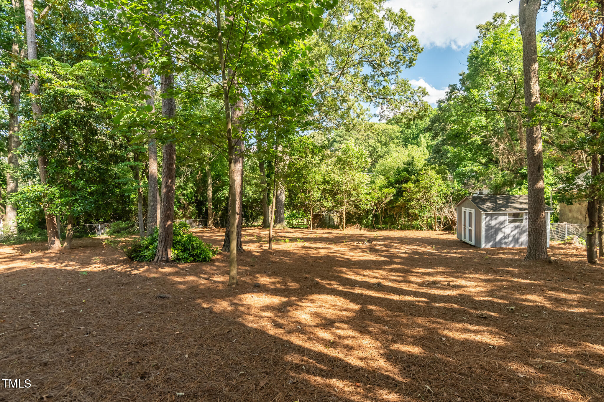 205 Northfield Drive Raleigh, NC 27609 - Photo 5 of 87 a view of a field with trees in the background