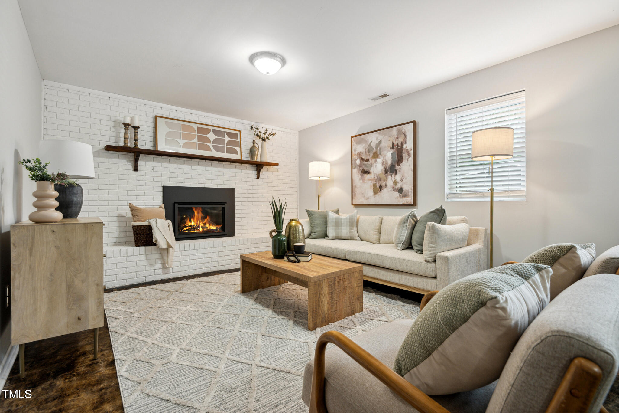 205 Northfield Drive Raleigh, NC 27609 - Photo 61 of 87 a living room with furniture and a fireplace