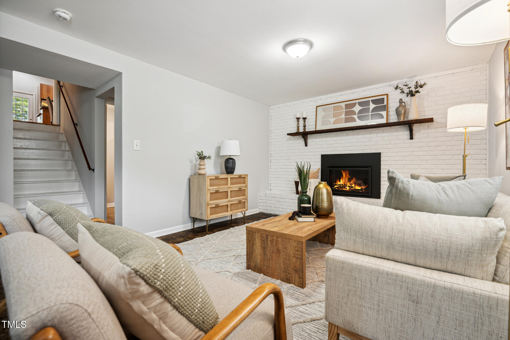 205 Northfield Drive Raleigh, NC 27609 - Photo 62 of 87 a living room with furniture and a fireplace
