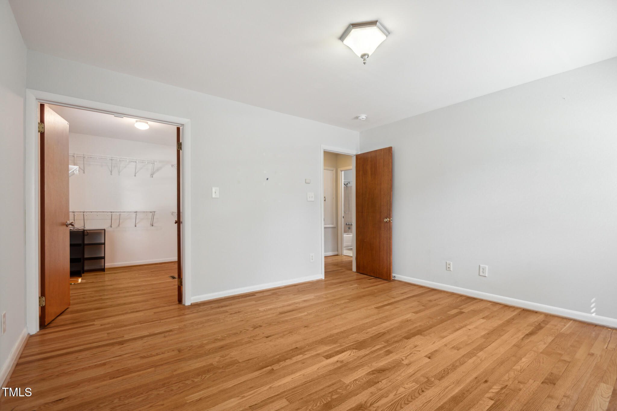 205 Northfield Drive Raleigh, NC 27609 - Photo 71 of 87 a view of an empty room with wooden floor