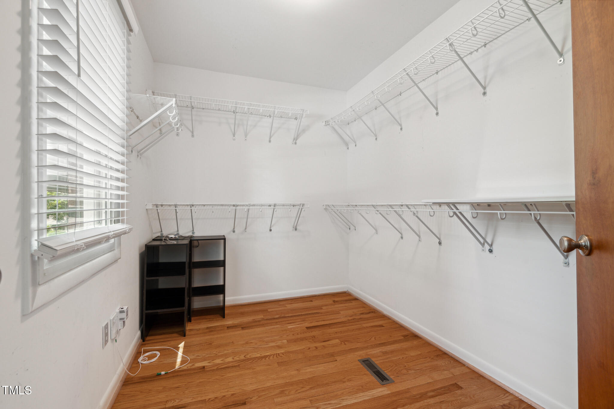 205 Northfield Drive Raleigh, NC 27609 - Photo 72 of 87 a view of walk in closet with empty racks