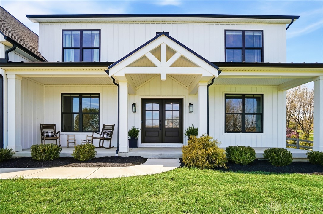 This classic facade features an inviting porch, showcasing timeless design and curb appeal.