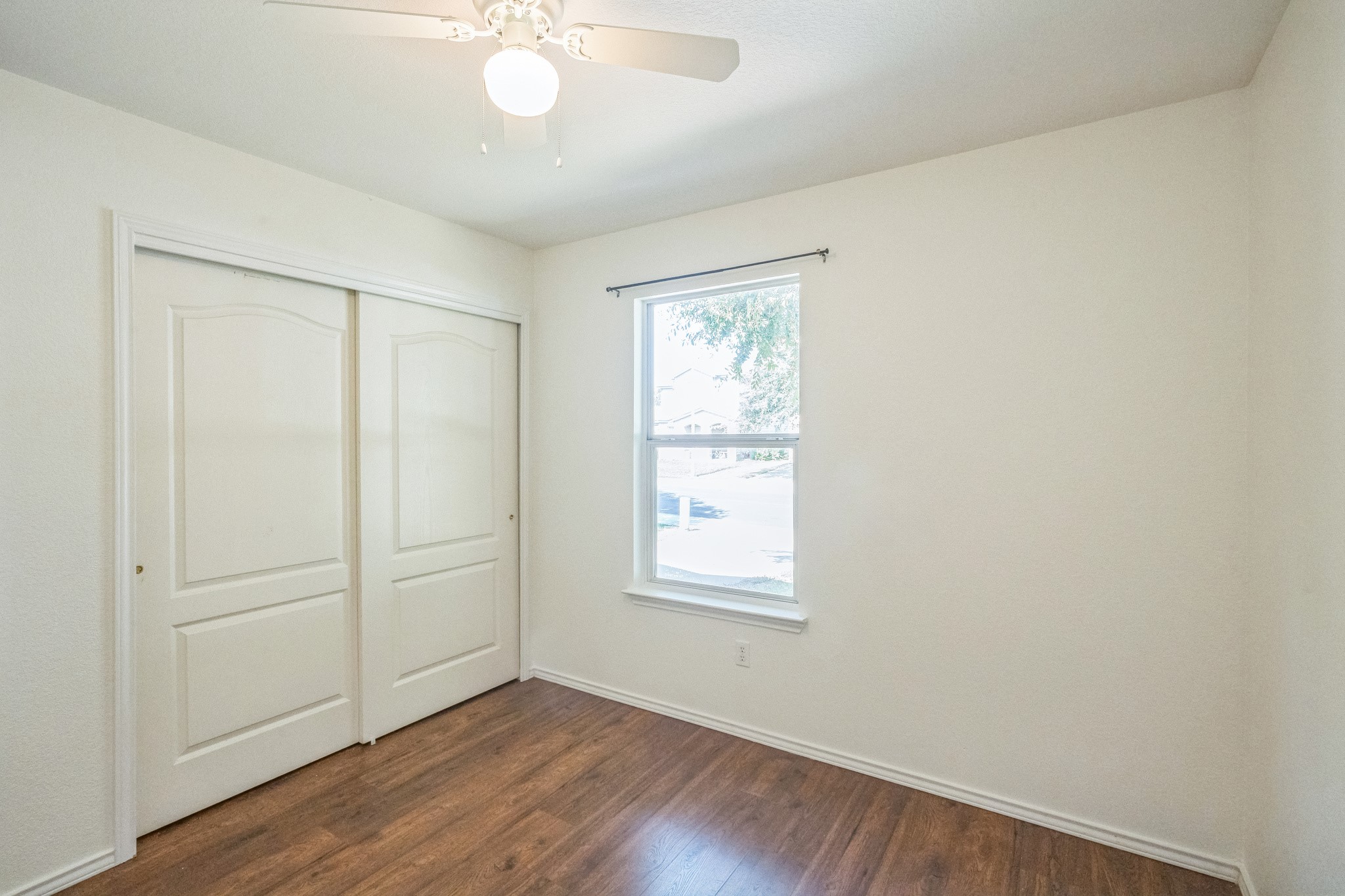77 Jan Lane Georgetown, TX 78626 - Photo 15 of 16 A well-lit room featuring rich hardwood flooring and convenient closet storage.