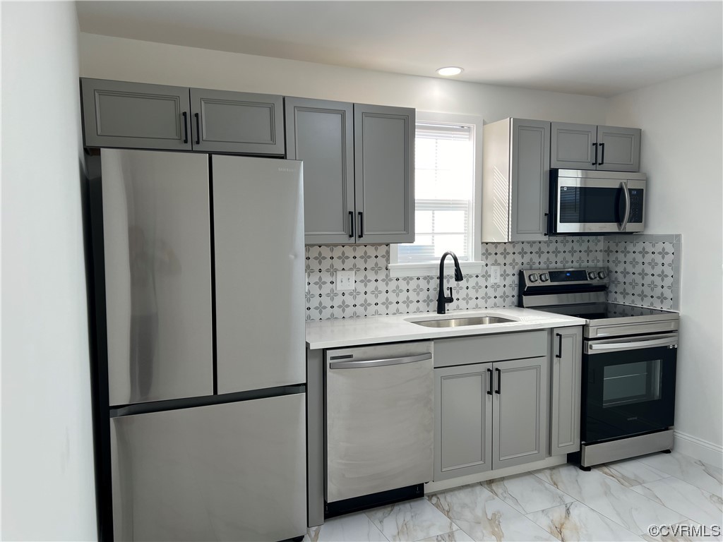 a kitchen with a sink appliances and cabinets