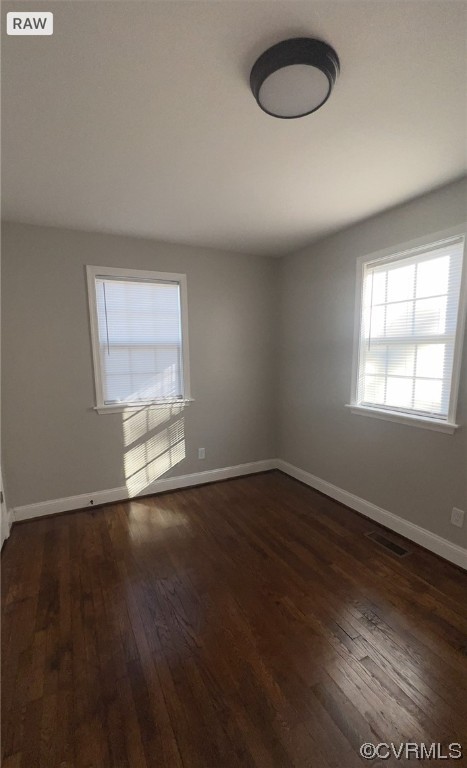 809 St James Street Petersburg, VA 23803 - Photo 4 of 9 an empty room with wooden floor and windows