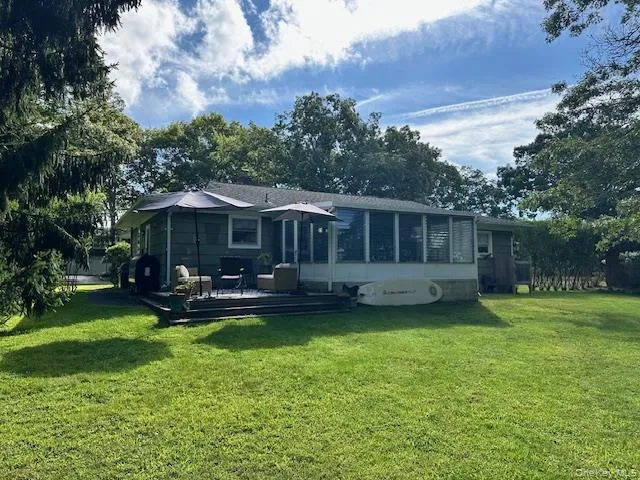 a front view of a house with a garden and swimming pool