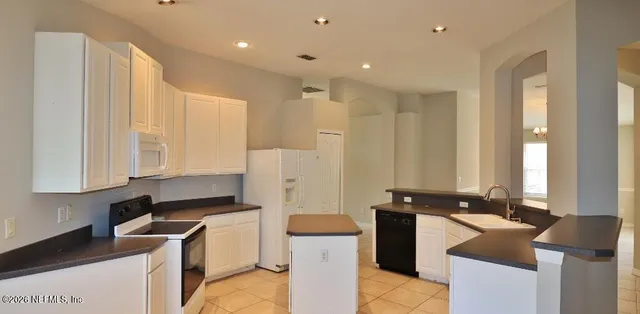 a kitchen with a sink stove and refrigerator