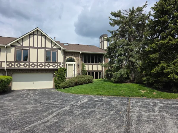 a front view of a house with a garden and yard
