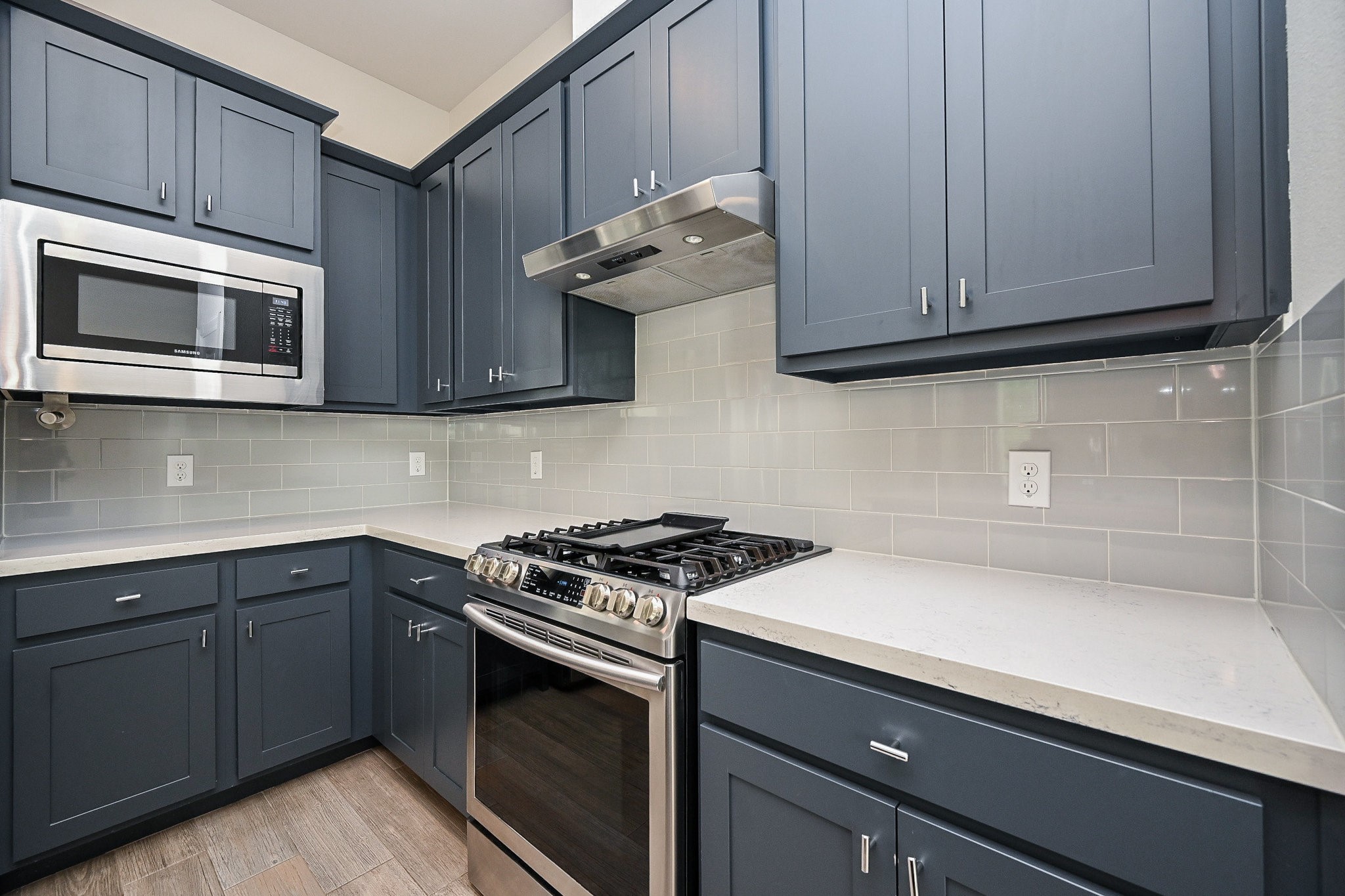 651 Press Street Houston, TX 77020 - Photo 4 of 20 a kitchen with stainless steel appliances granite countertop a sink dishwasher a stove microwave and cabinets
