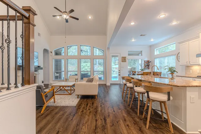 a kitchen with stainless steel appliances granite countertop a table and chairs