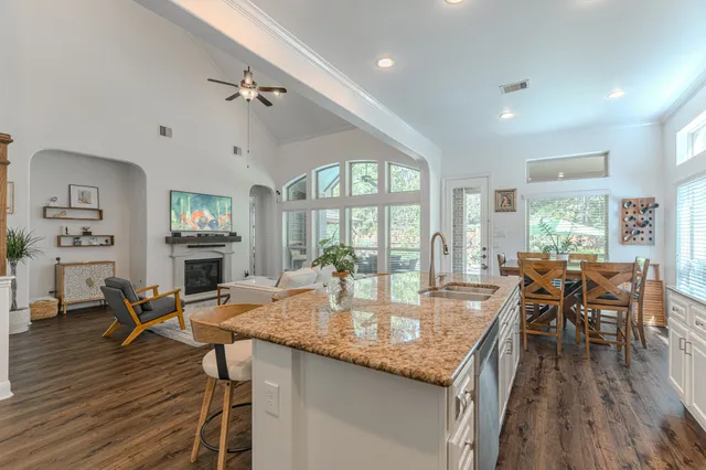 a living room with furniture a fireplace and a floor to ceiling window