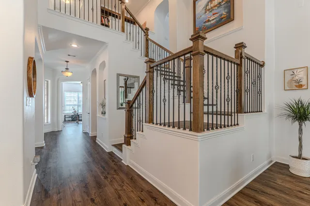a view of entryway and hall with wooden floor
